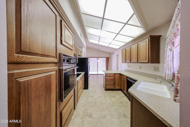 kitchen with a sink, light countertops, a peninsula, vaulted ceiling, and black appliances