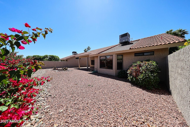 back of house with a patio, a fenced backyard, stucco siding, central AC unit, and a tiled roof