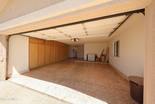 garage with a garage door opener and electric water heater