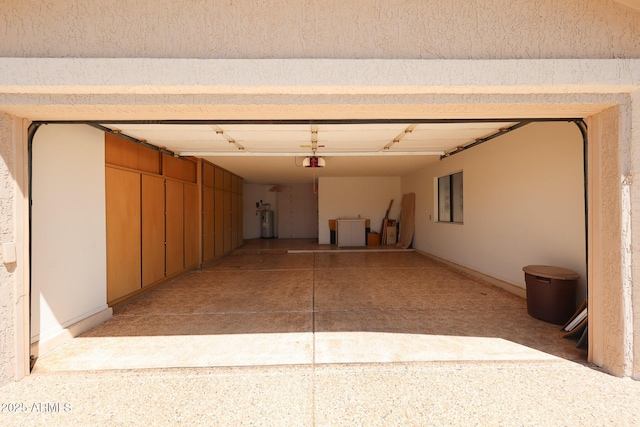 garage featuring water heater and a garage door opener