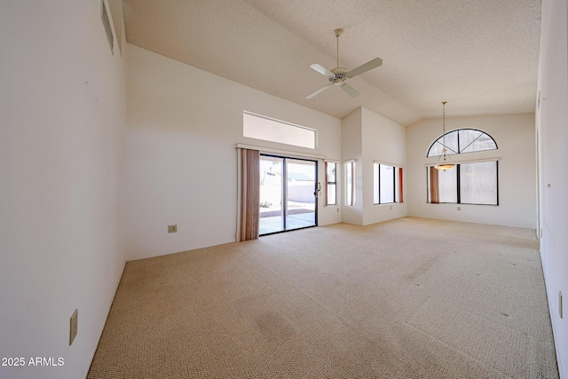 unfurnished room featuring light colored carpet, a ceiling fan, a healthy amount of sunlight, and high vaulted ceiling