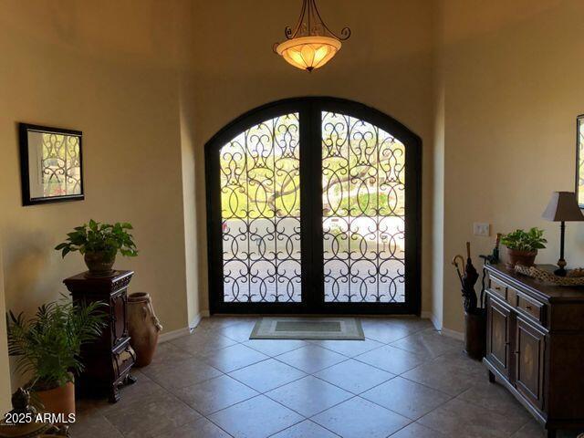35401 N Via Tramonto St, Phoenix, AZ 85086 - tiled entrance foyer featuring arched walkways and baseboards