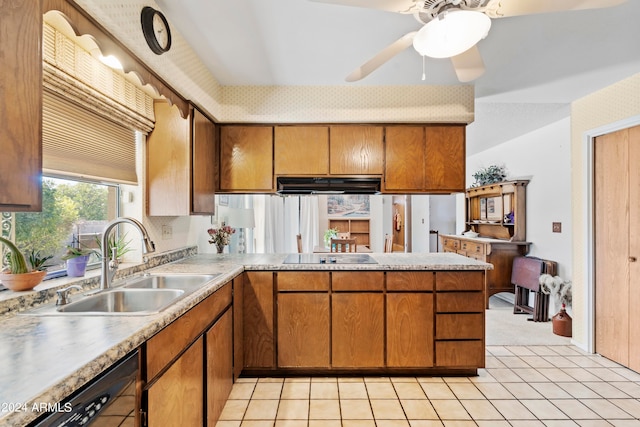 kitchen with light countertops, brown cabinetry, a sink, under cabinet range hood, and black appliances