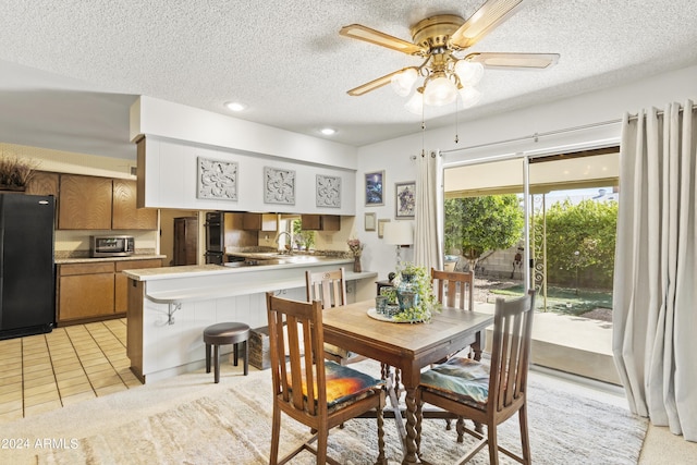 dining area with light tile patterned floors, a ceiling fan, recessed lighting, and a textured ceiling
