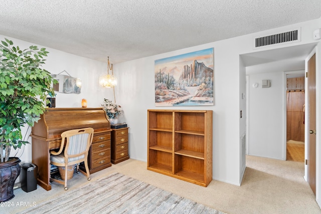 office area with light carpet, a textured ceiling, visible vents, and baseboards