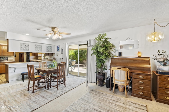 dining room featuring light colored carpet, a ceiling fan, and a textured ceiling
