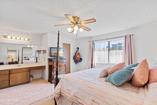 bedroom with light carpet, ceiling fan, and a textured ceiling