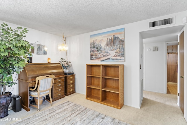 carpeted home office featuring visible vents, a textured ceiling, and baseboards