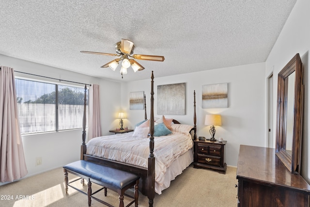 bedroom featuring carpet floors, a ceiling fan, and a textured ceiling