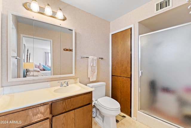 ensuite bathroom featuring visible vents, toilet, a shower stall, ensuite bath, and vanity