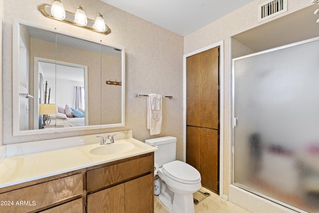 full bath featuring vanity, a stall shower, toilet, and visible vents