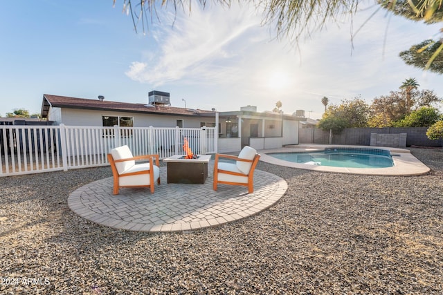 view of swimming pool featuring a fire pit, cooling unit, and a patio