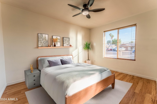 bedroom with light hardwood / wood-style flooring and ceiling fan