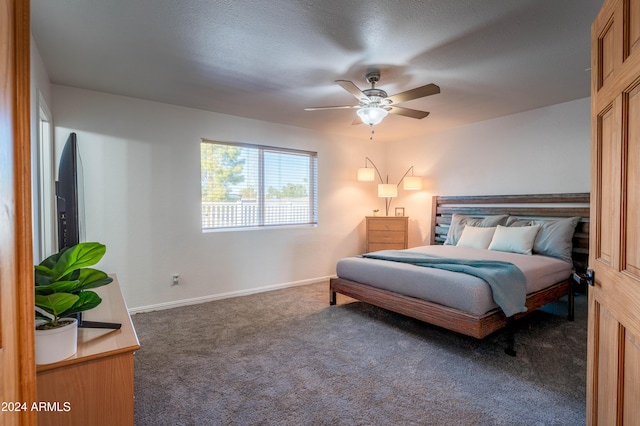 bedroom with ceiling fan and dark carpet