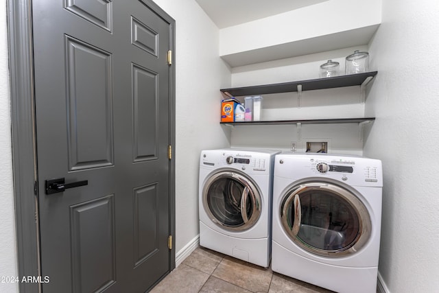 washroom featuring washing machine and clothes dryer and light tile patterned flooring