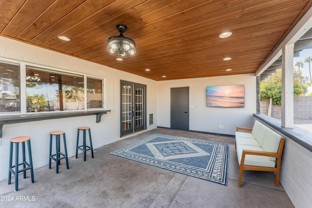 sunroom featuring wooden ceiling