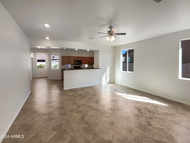 unfurnished living room with ceiling fan