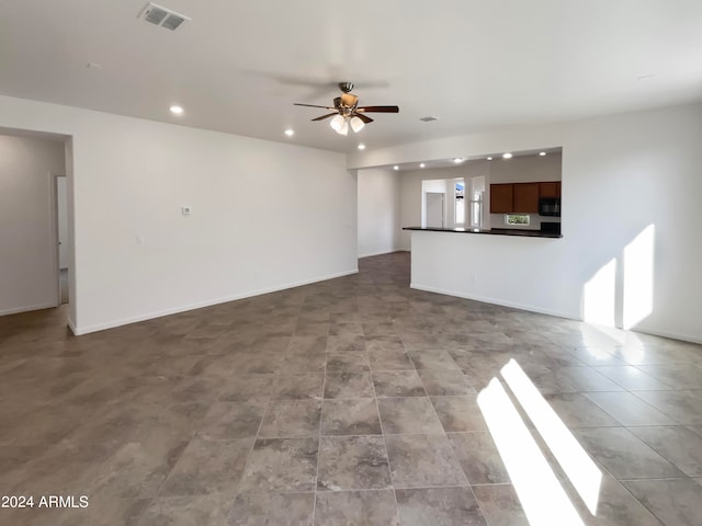 unfurnished living room with ceiling fan