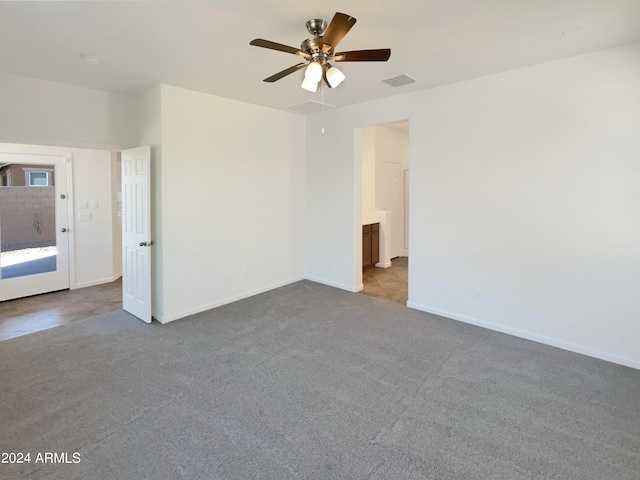 spare room featuring light carpet and ceiling fan