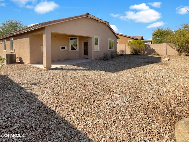 rear view of property featuring a patio and central AC