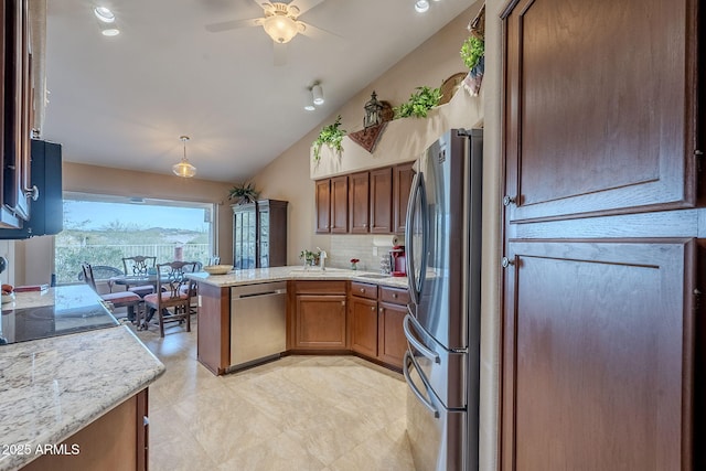 kitchen with ceiling fan, stainless steel appliances, tasteful backsplash, kitchen peninsula, and vaulted ceiling