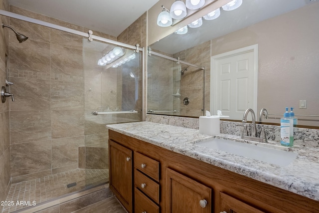 bathroom with vanity and a shower with door