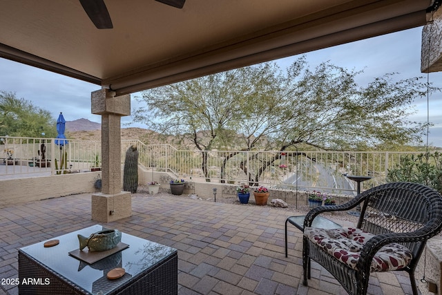 view of patio / terrace with a mountain view and ceiling fan