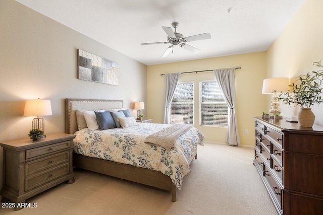 bedroom with baseboards, a ceiling fan, and light colored carpet