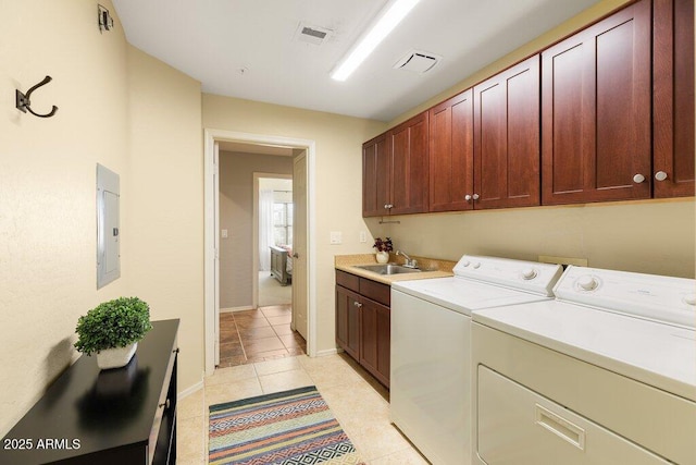 washroom featuring visible vents, cabinet space, a sink, and washer and clothes dryer