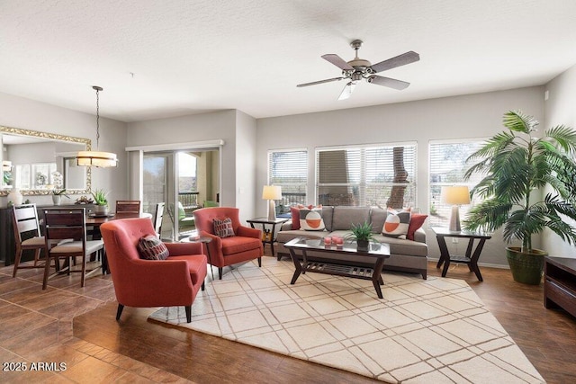 living area with wood finished floors and a ceiling fan