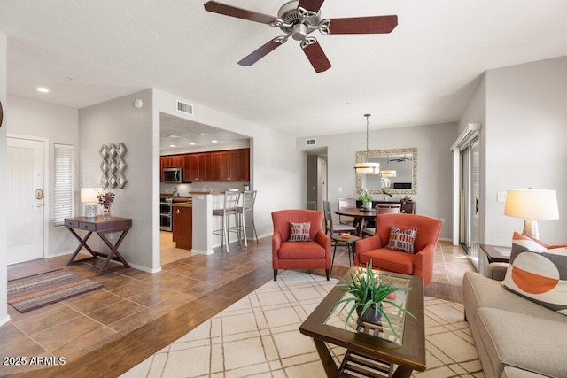 living room with baseboards, visible vents, and recessed lighting