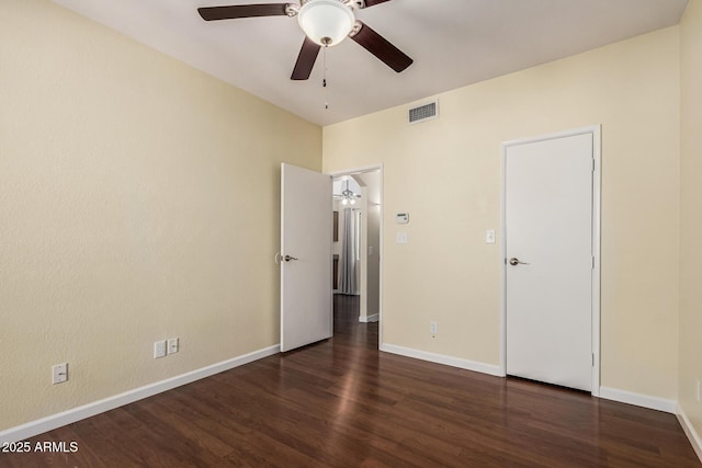 unfurnished bedroom with ceiling fan, visible vents, baseboards, and wood finished floors