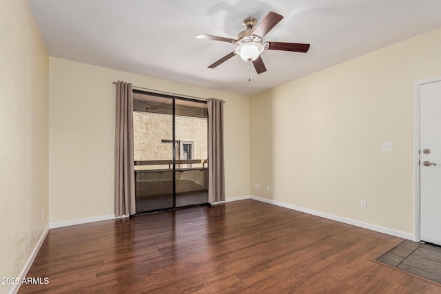 spare room with baseboards, ceiling fan, and wood finished floors