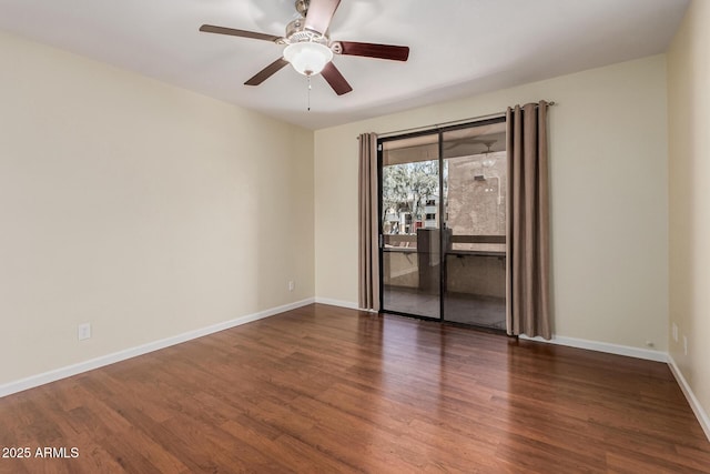 spare room with a ceiling fan, wood finished floors, and baseboards