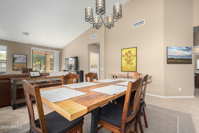 dining area featuring high vaulted ceiling and a chandelier