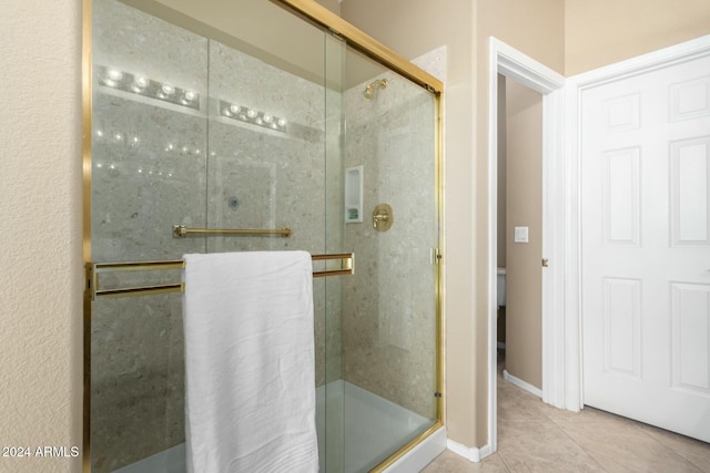 bathroom featuring tile patterned floors and an enclosed shower