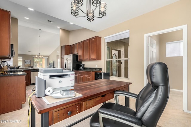 kitchen with kitchen peninsula, appliances with stainless steel finishes, vaulted ceiling, pendant lighting, and a chandelier