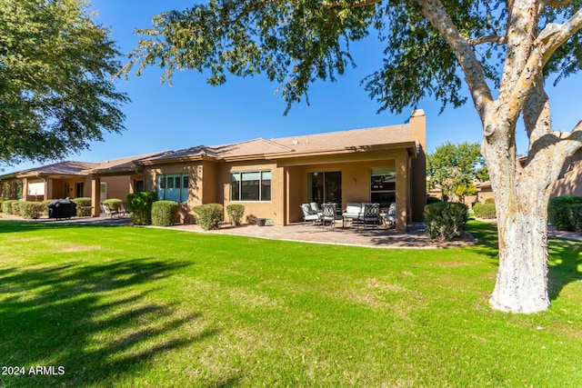 back of house with a lawn, outdoor lounge area, and a patio