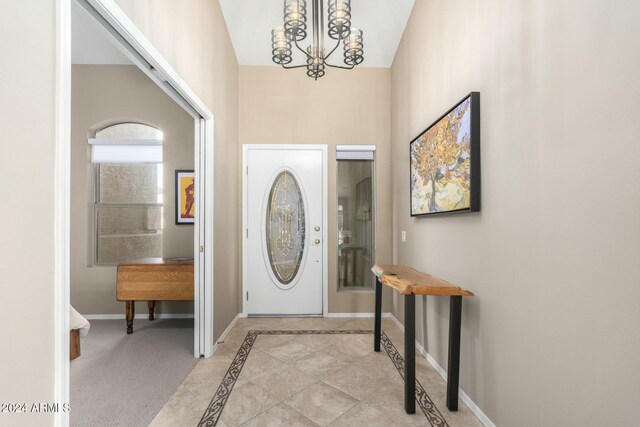 foyer with a chandelier and high vaulted ceiling