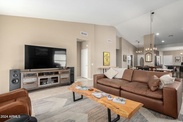 living room featuring high vaulted ceiling and a chandelier