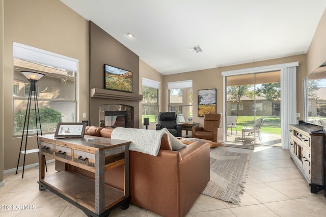 tiled living room with a high end fireplace and high vaulted ceiling