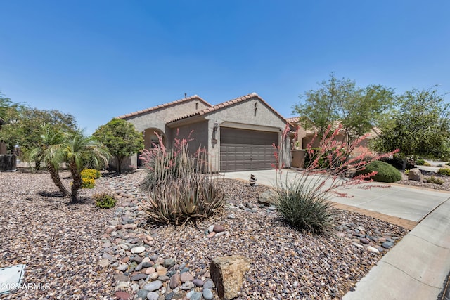 mediterranean / spanish home with an attached garage, stucco siding, a tiled roof, driveway, and central AC unit