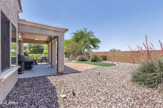 fenced backyard featuring a patio area