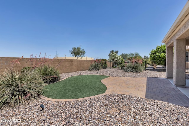 fenced backyard with a patio