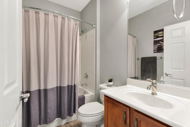 bathroom featuring toilet, shower / bath combo with shower curtain, and vanity