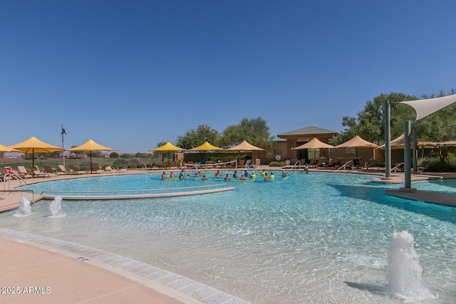community pool with fence and a patio