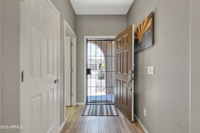 entryway featuring light wood finished floors and baseboards