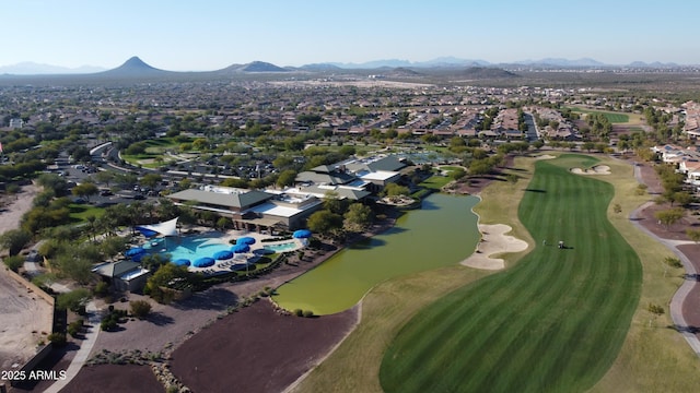 view of property location with nearby suburban area, a water and mountain view, and a golf club