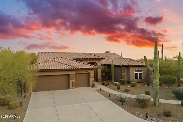 mediterranean / spanish home featuring a garage