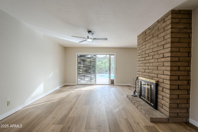 unfurnished living room with a fireplace, light wood-type flooring, and ceiling fan